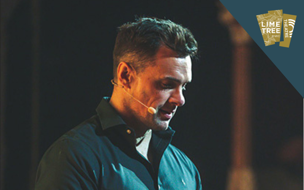 A man with small mic over his ear in looking downwards