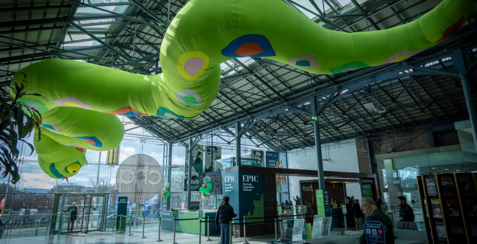 Giant green inflatable snake hanging from the ceiling of the CHQ building, ready for St Patrick's weekend activity
