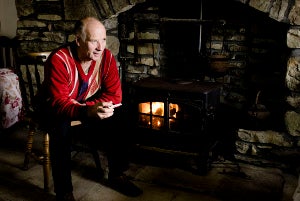 Image of farmer by fireside