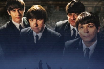 4 men in suits and ties and beatle hair cuts