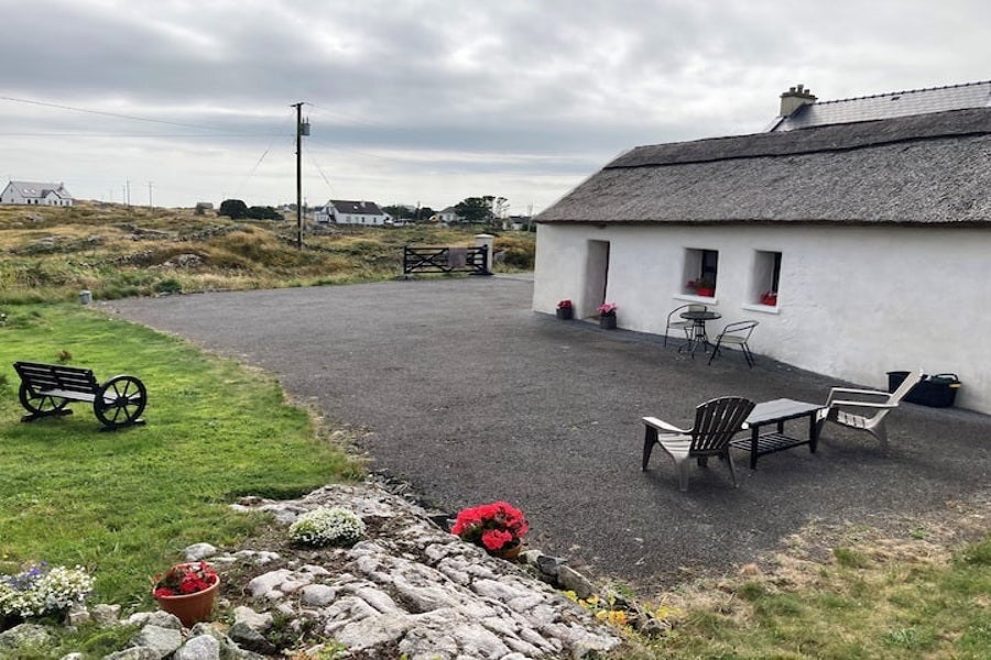 Exterior of the cottage with countryside view.