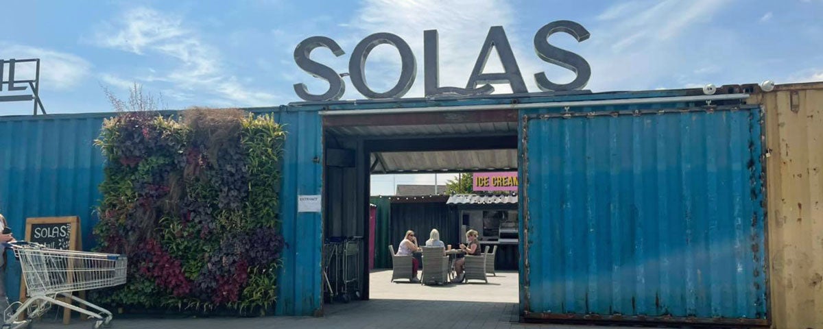 Entrance area of Garden Centre which goes through a doorway cut out of a blue shipping container