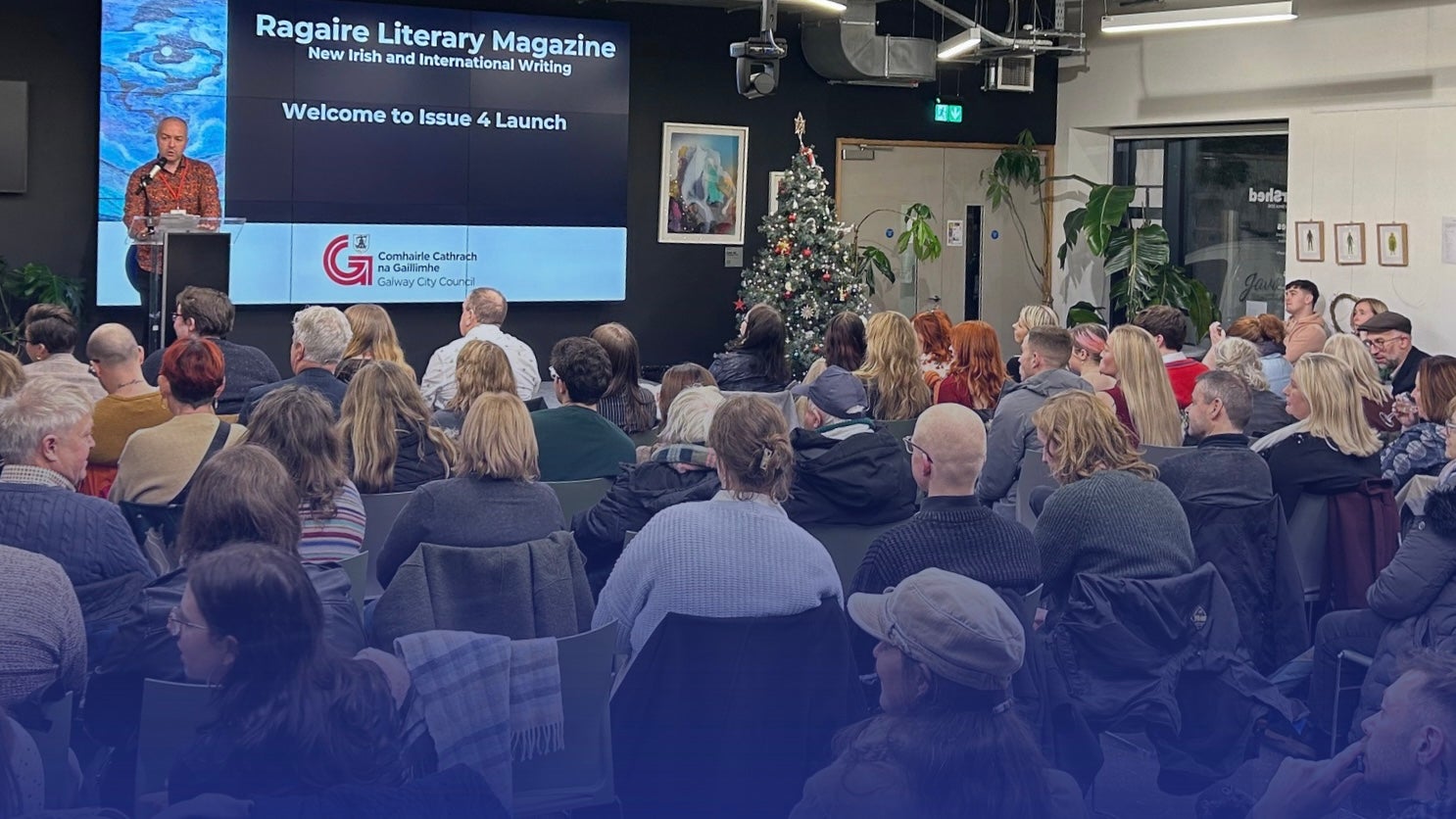 Ragaire Launch at the Portershed, a seated audience looking at a speaker on a stage.