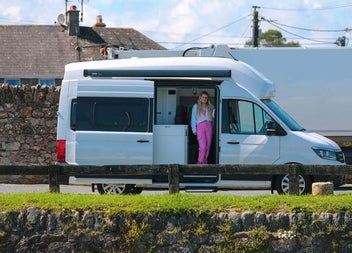 Girls standing at the side door of a Cookies Camper
