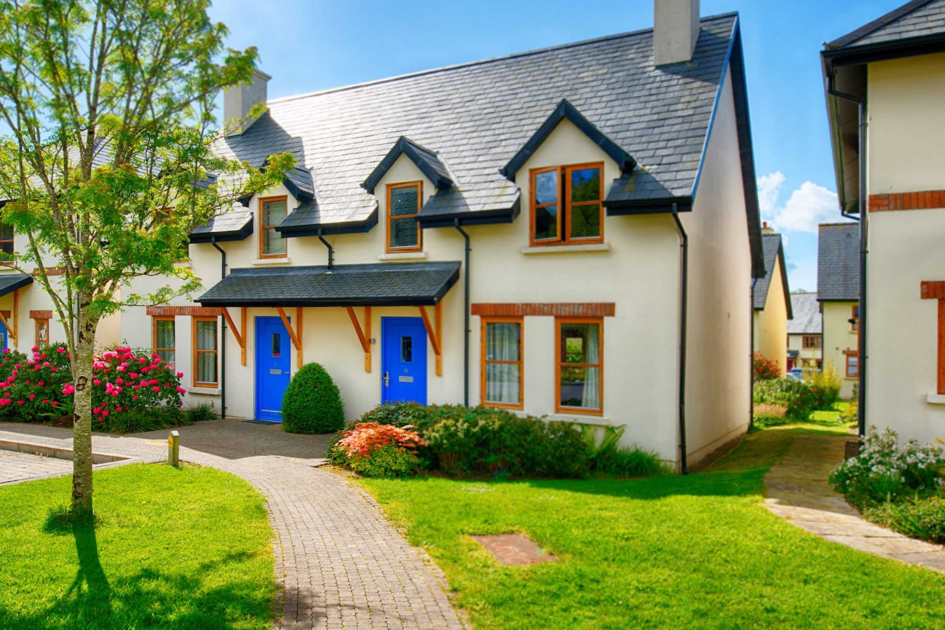 Exterior of lodges with mature shrubs.