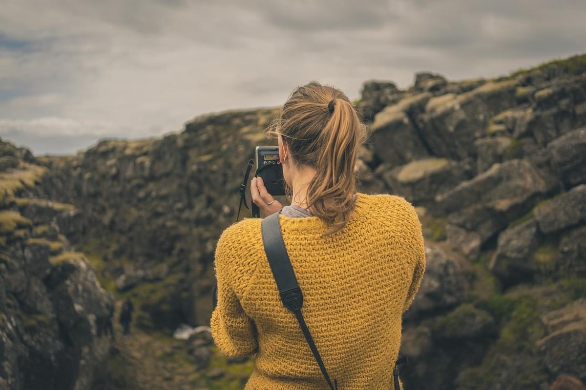A lady taking a photograph while on a tour with Killarney Photo Tours