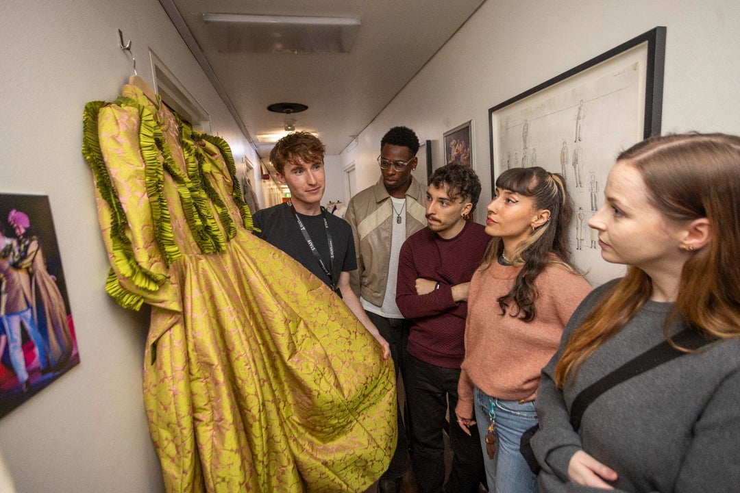 People looking at a costume dress backstage with Abbey Theatre Tours