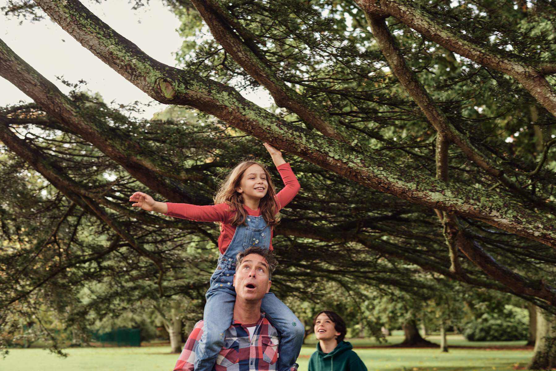 Two children and their father tour the Malahide Gardens. 