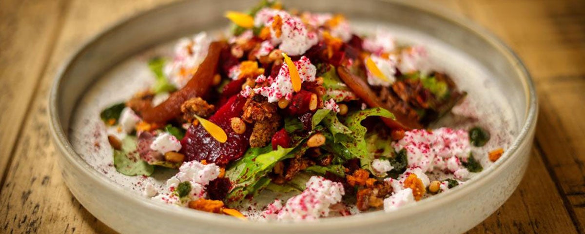 A plate with a mix of rice and peppers and greens from House of Plates Restaurant