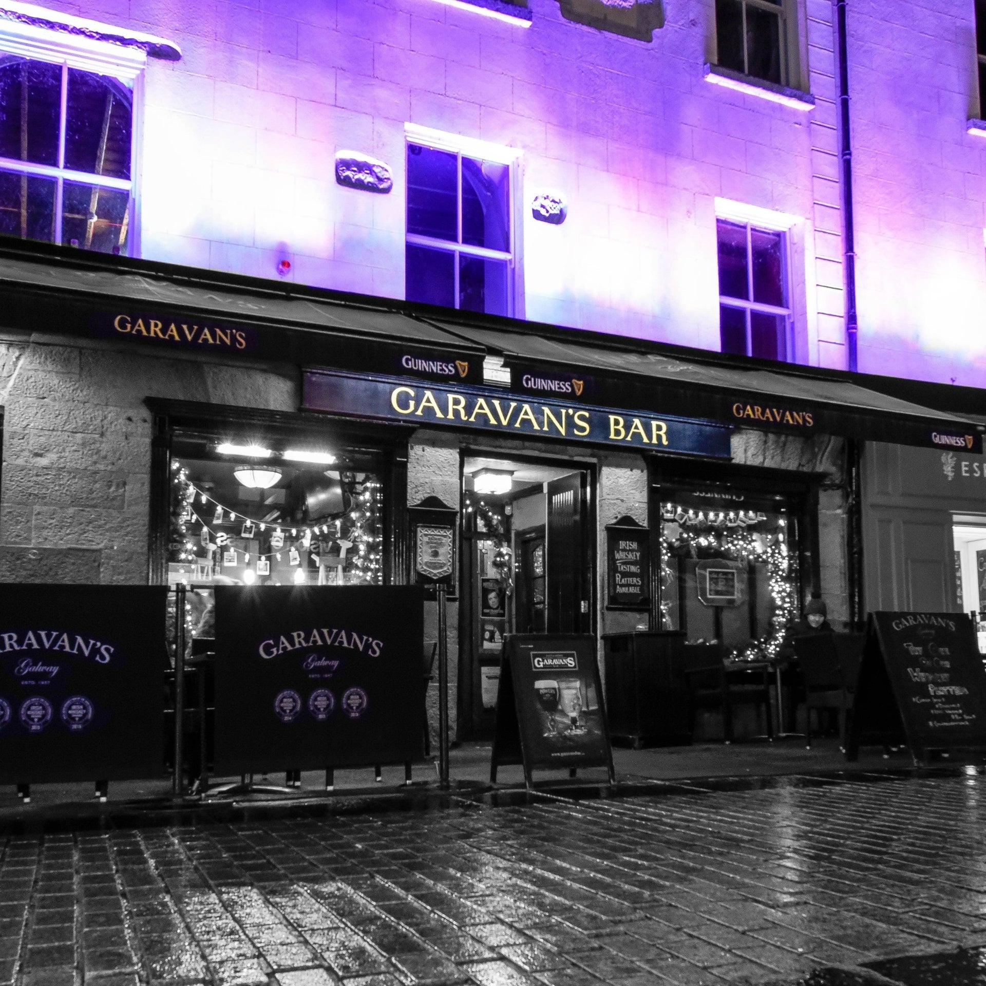 Exterior of a pub in the evening with the lights on