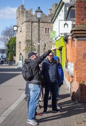People on a street with a tour guide