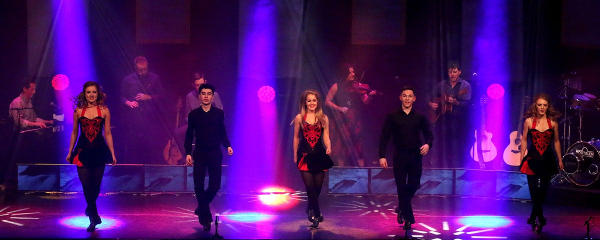 Dancers performing on stage with Trad on the Prom
