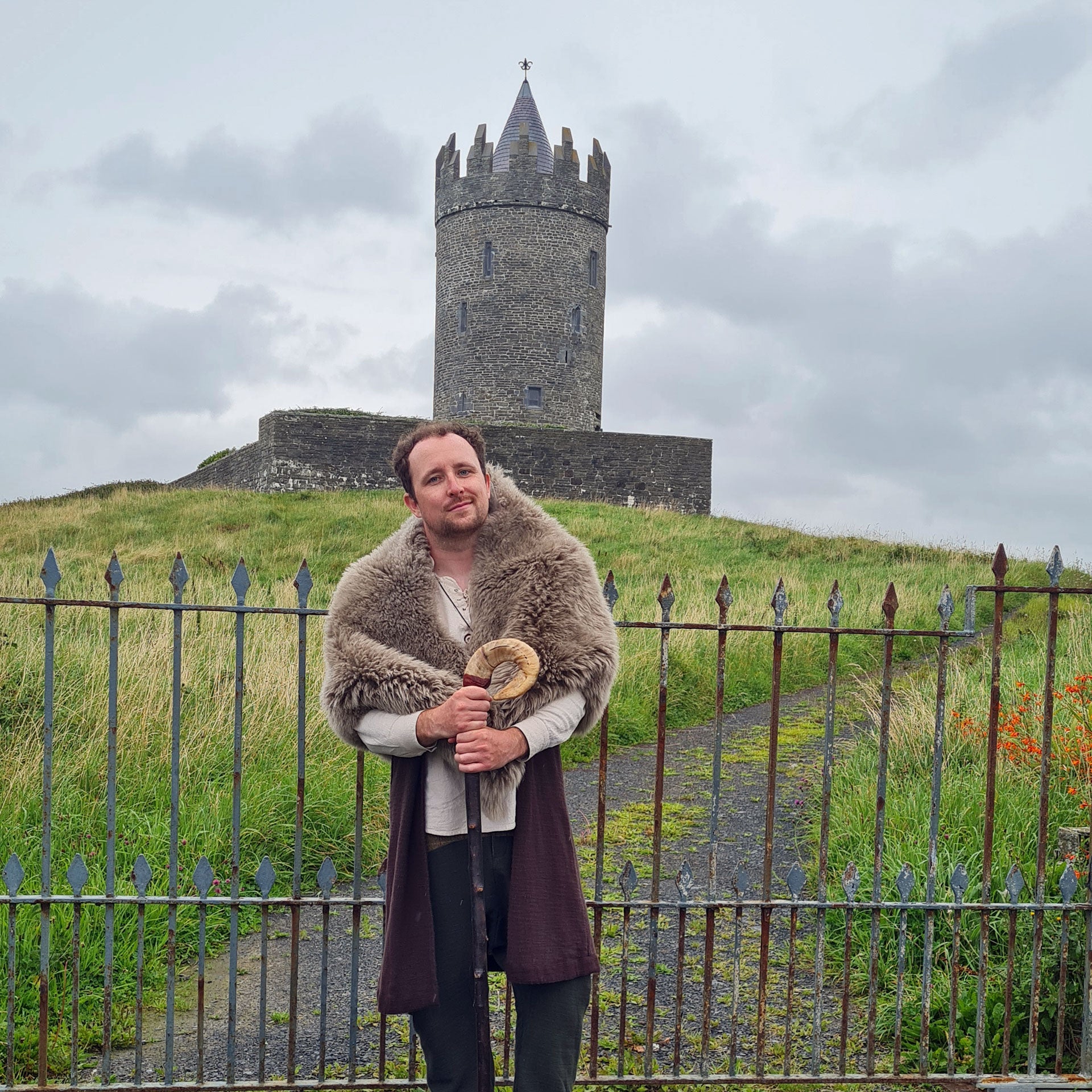 Balor Otherworld guide telling stories in front of an old stone tower