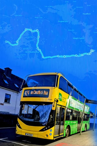 A bus drives through Galway, the route map highlighted on the sky behind it.