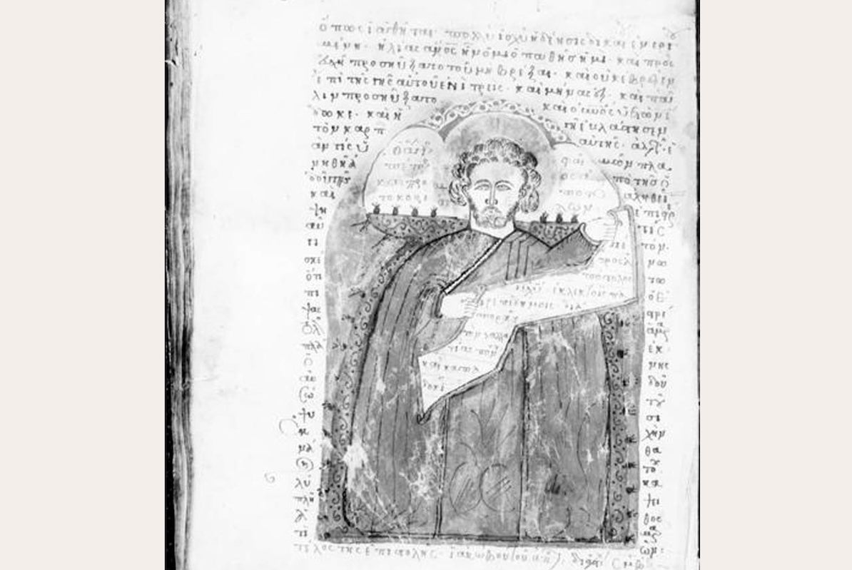 Faded picture of old manuscript with fancy text and picture of ancient person