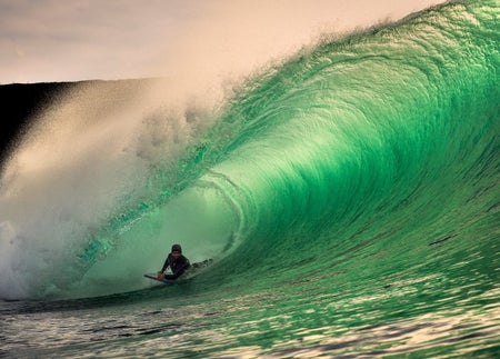 A man surfing a huge wave with Adventure Legend