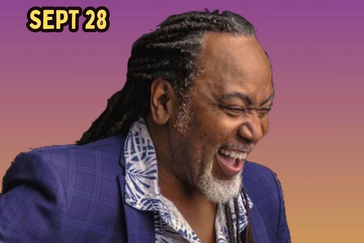 A laughing man with eyes shut.