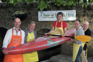 People holding up a woman in a kayak at Lough Derg Watersports