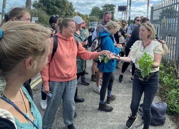 Guide handing out foraging produce