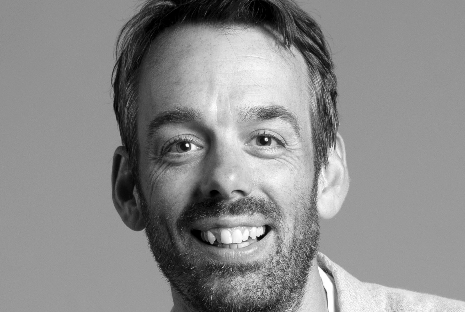 The head and shoulders of Chris Finnegan. He is smiling.