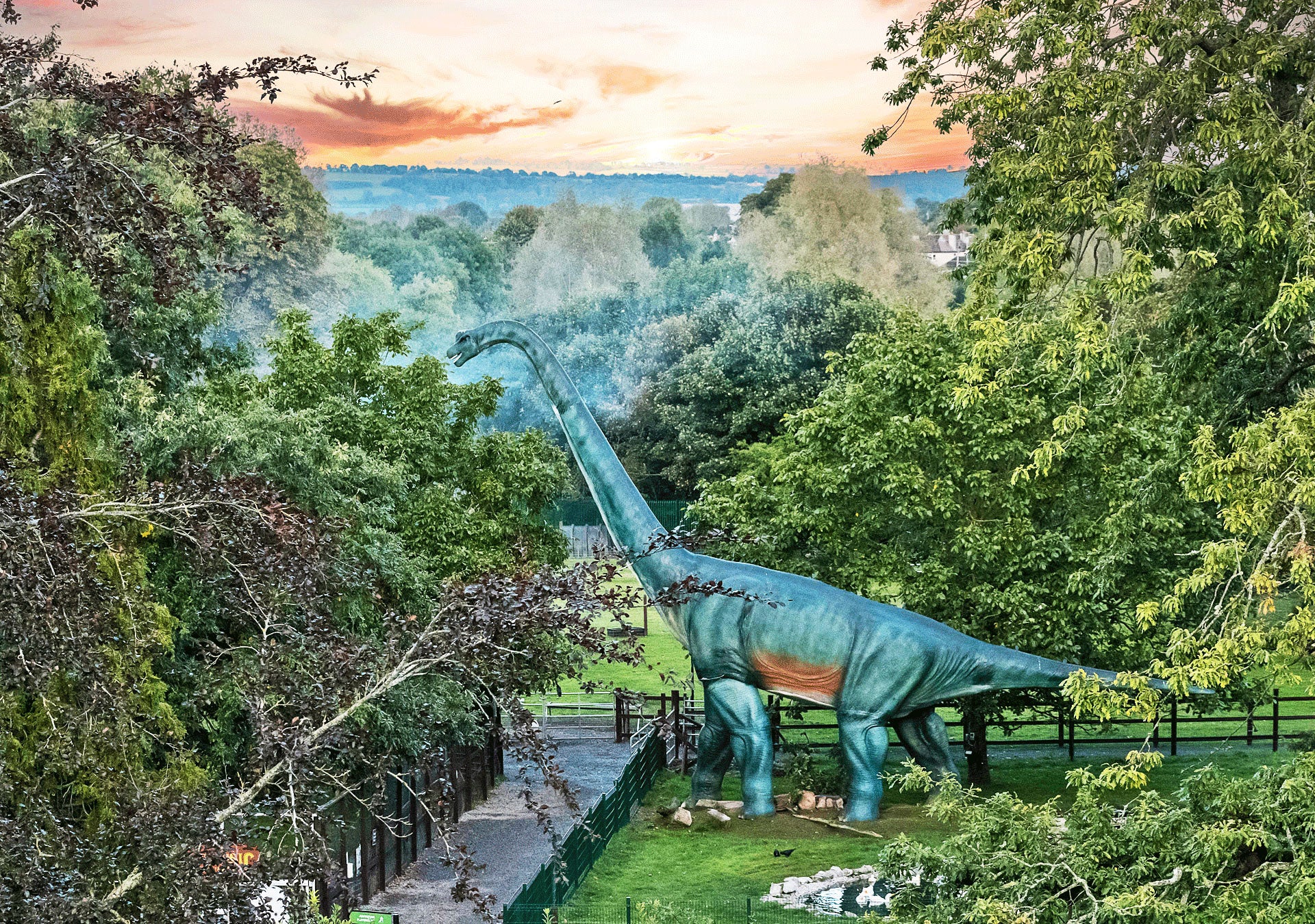 Jurassic Newpark aerial view of the park with a life size dinosaur model