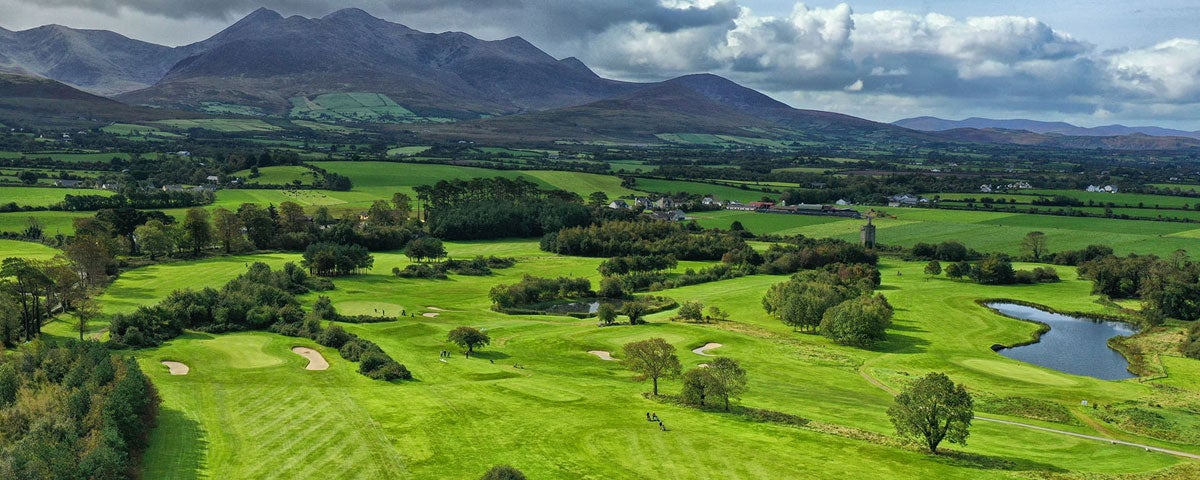 View of Beaufort Golf Course under a cloudy sky with hills in background