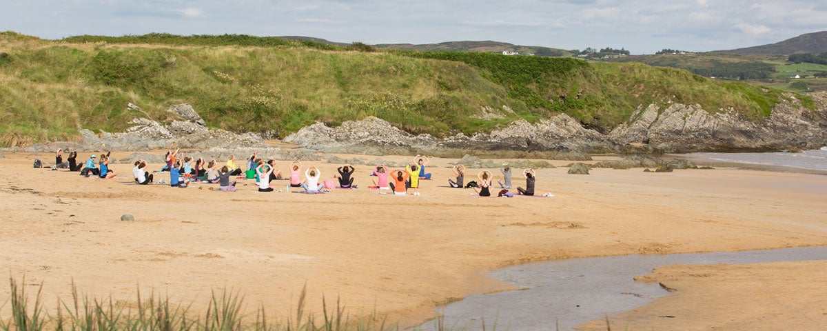 Yoga on the beach beside a stream at Inishowen Yoga Carndonagh County Donegal