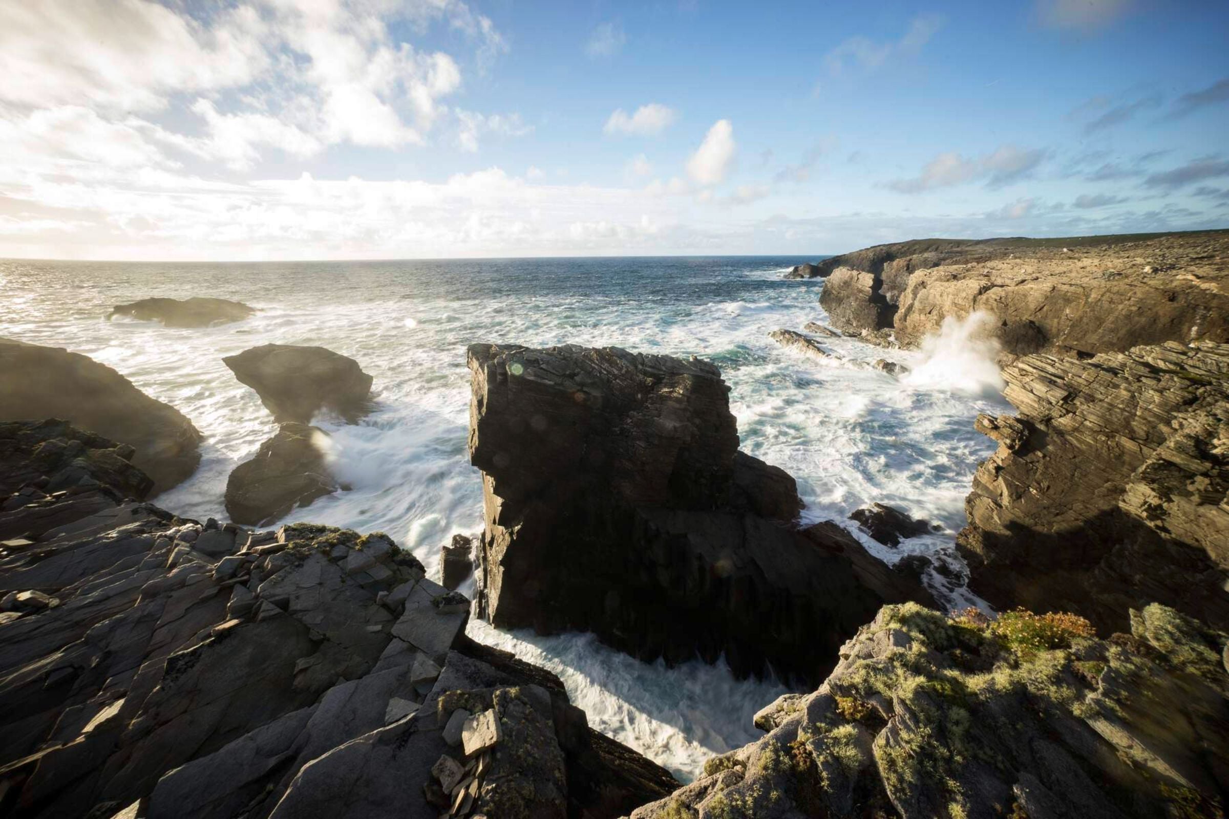 Waves from the Atlantic ocean crashing against cliffs at Dún na mBo in County Mayo.