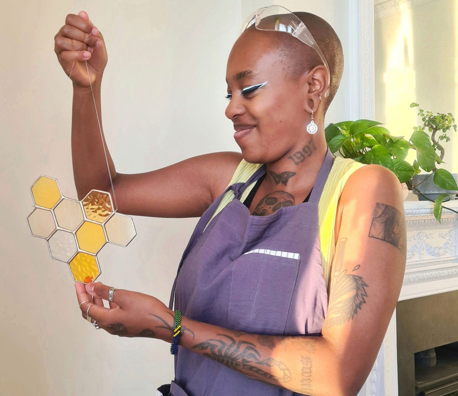 Lady holding a honeycombed shaped piece of stained glass