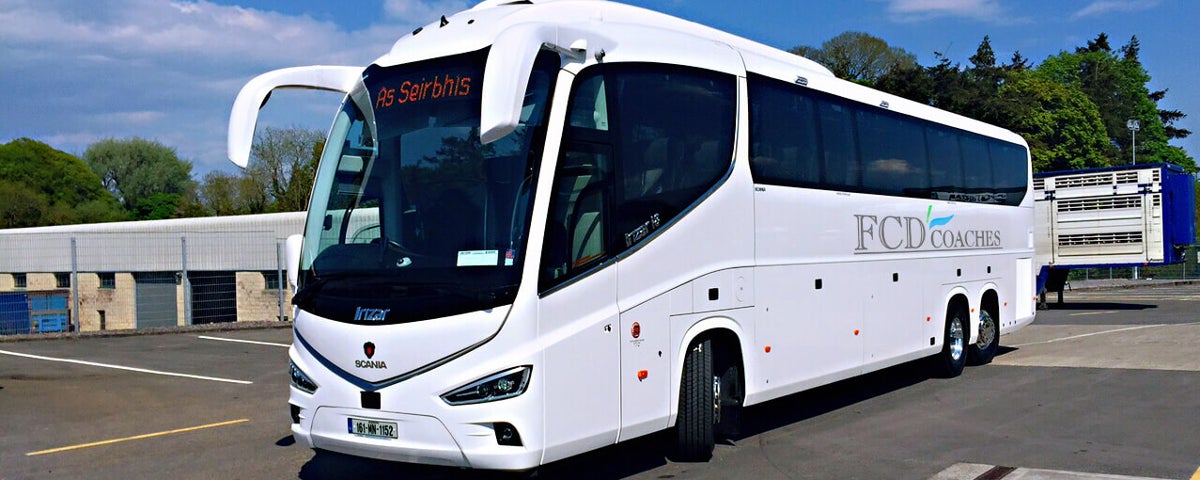 White FCD tour coach on the road