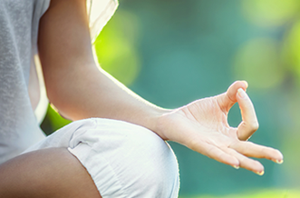 Dublin Mind Body Experience - partial view of person seated crossed legged resting upward facing hand on knee