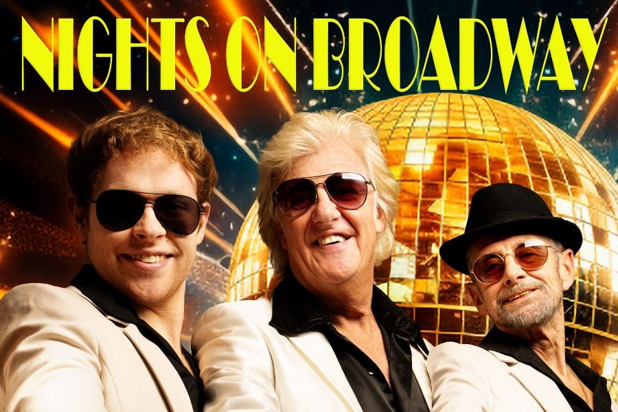 3 smiling men in white suits and dark shirts, all wearing sunglasses with gold, mosaic disco ball in background.