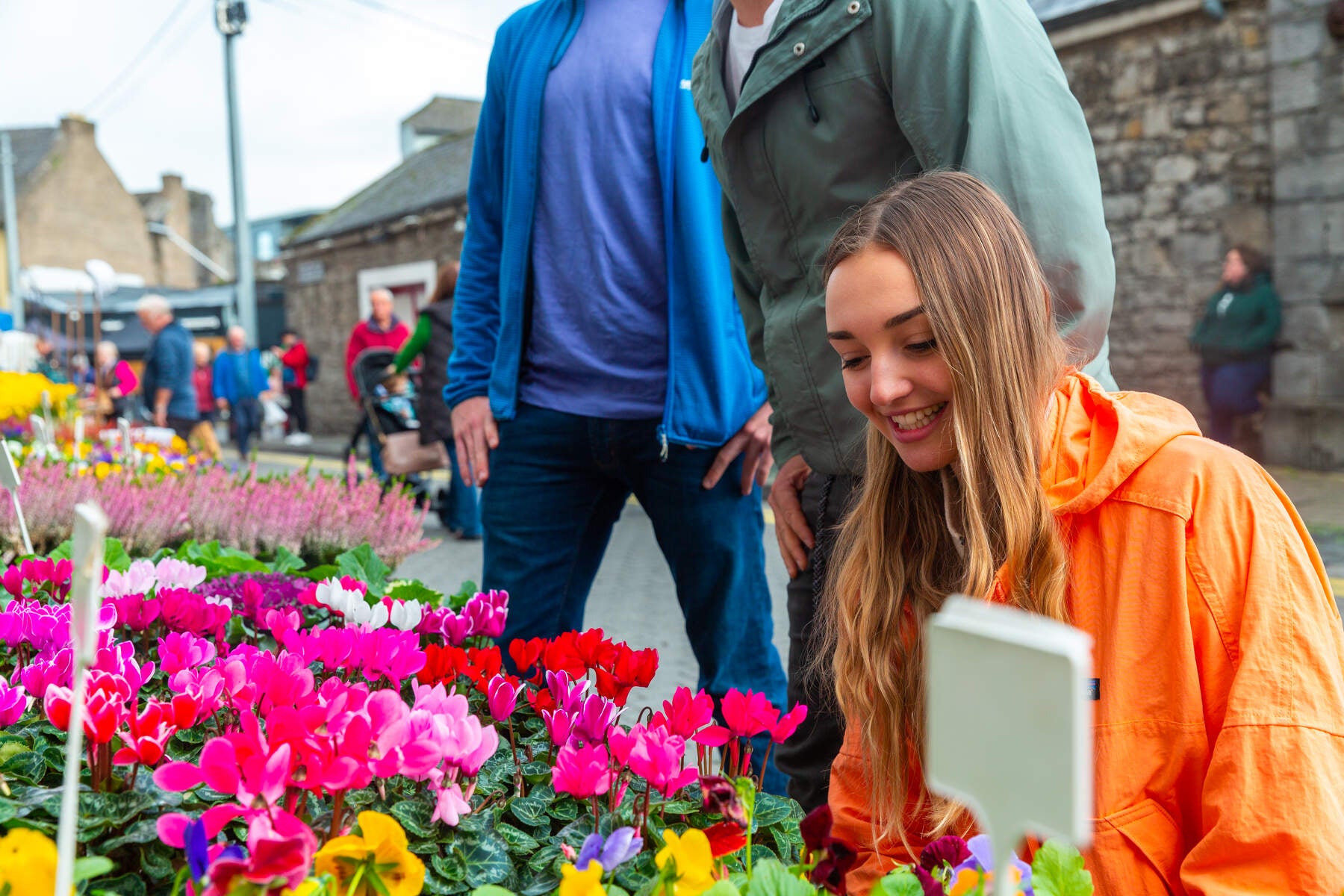 Young woman browsing flowers at The Milk Market in Limerick. 