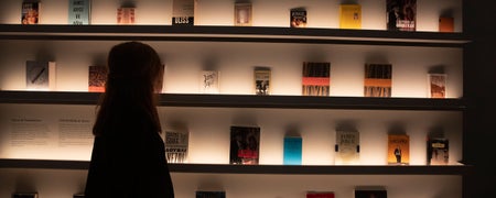 Lady standing looking at some of the books on display from Irish writers in the Museum of Literature Ireland