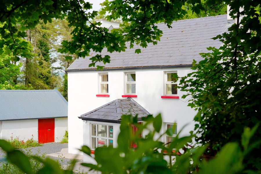 exterior of house surrounded by mature trees