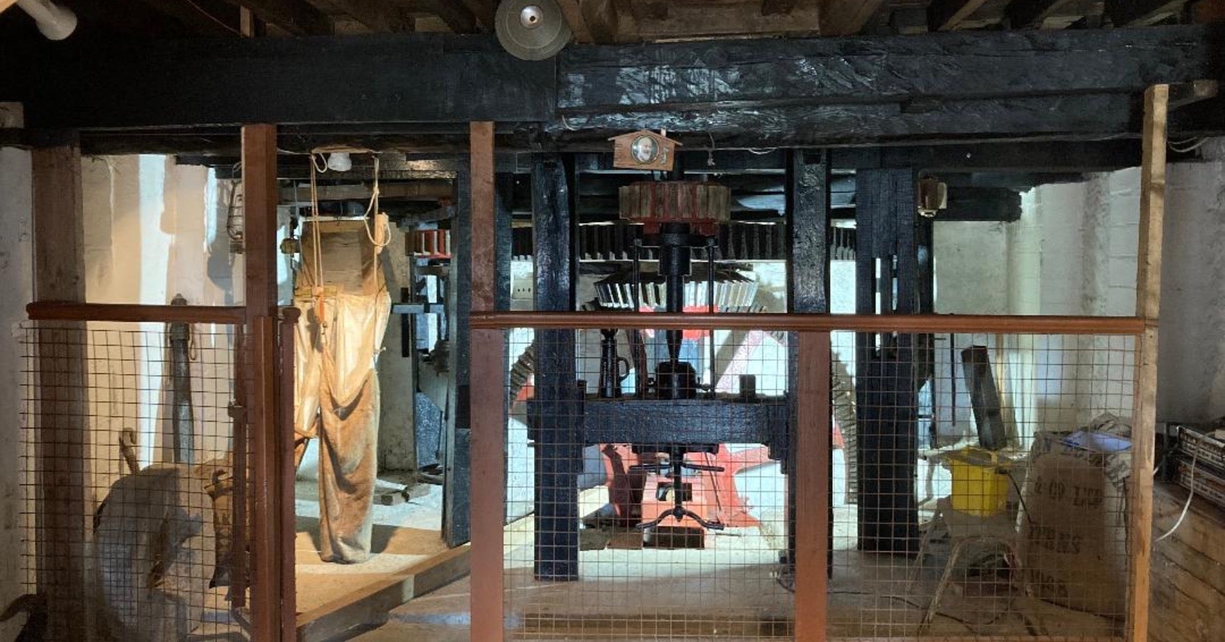 The interior of Craanford Mills with the restored water wheel in the middle