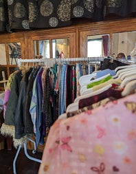 Some clothing rails with vintage clothes for sale at a market