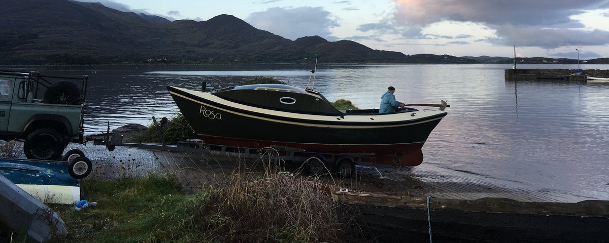 A boat moored beside the sea with its skipper