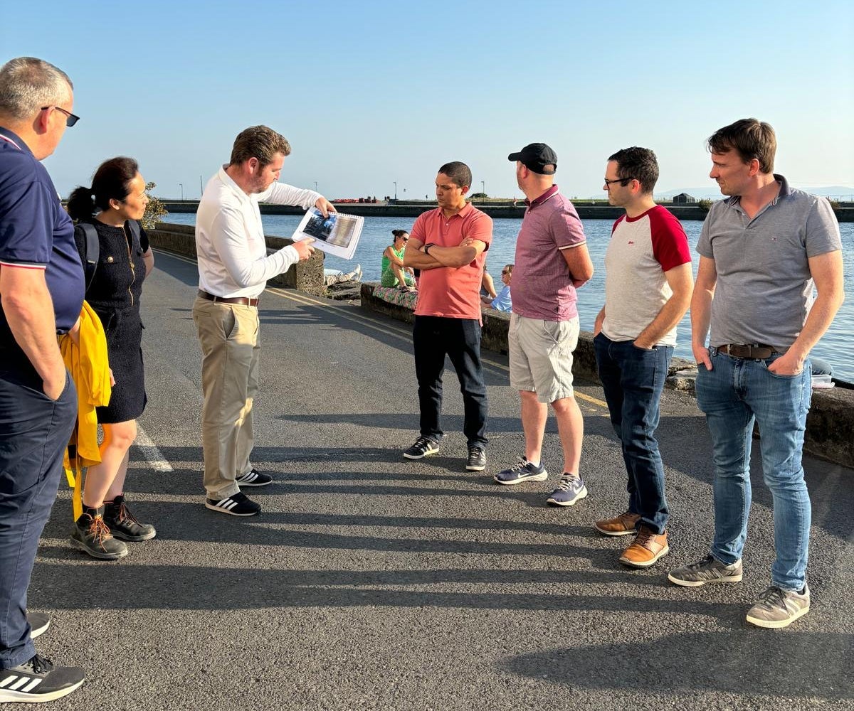 A group of people standing beside the water
