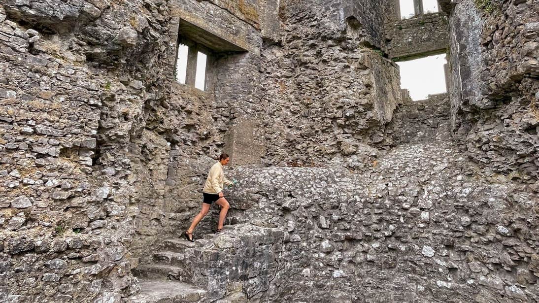 Roz Purcell climbing a stone staircase in Roscommon Castle