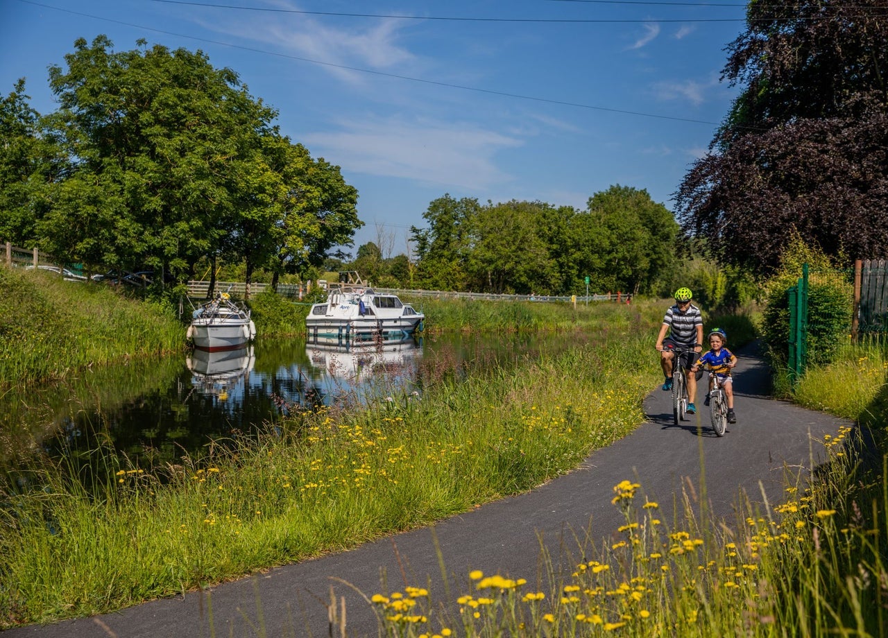 Two cyclists on a river path