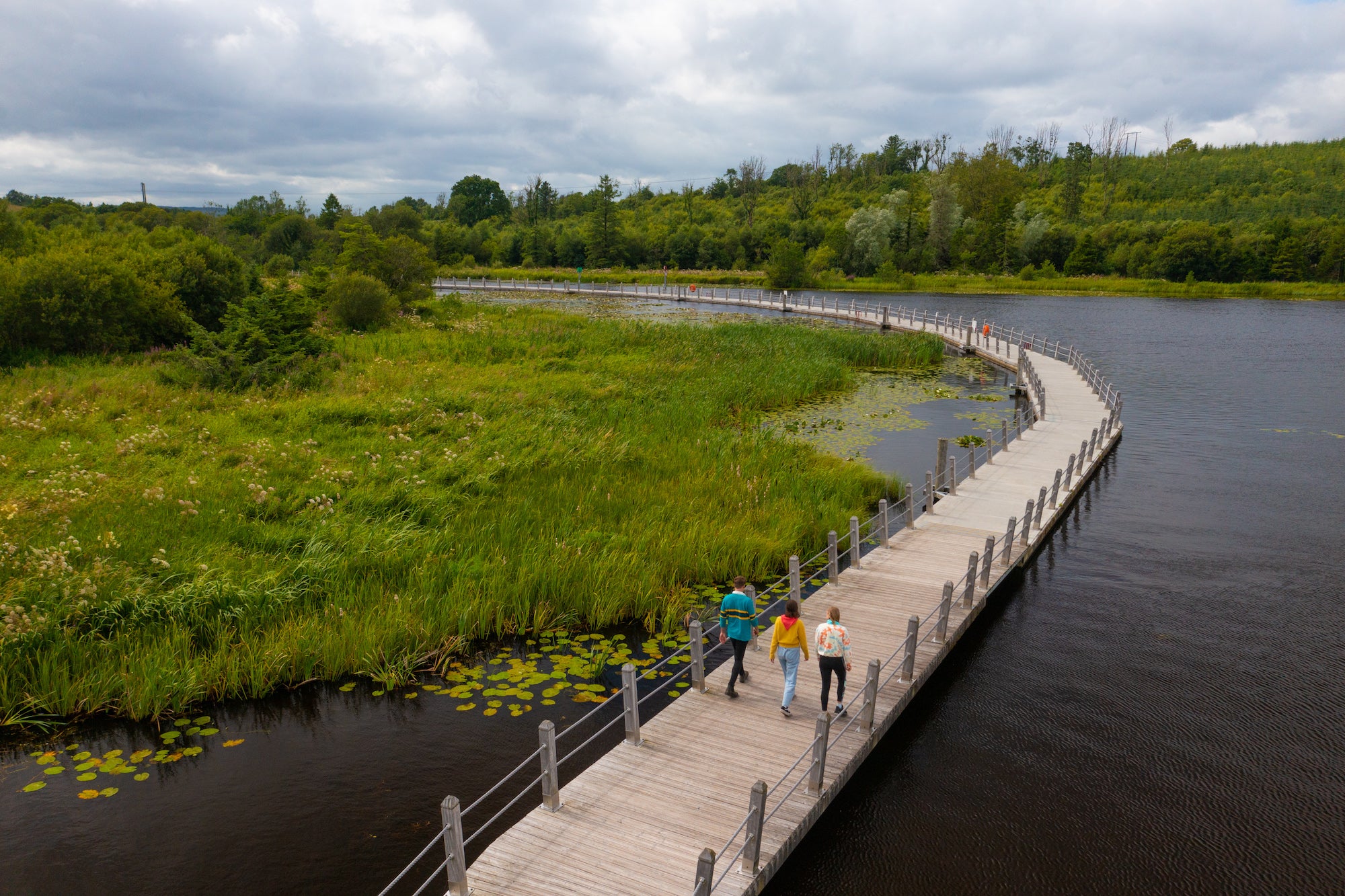 People walking on the Acres Lake Floating Boardwalk in Drumshanbo, Co Leitrim