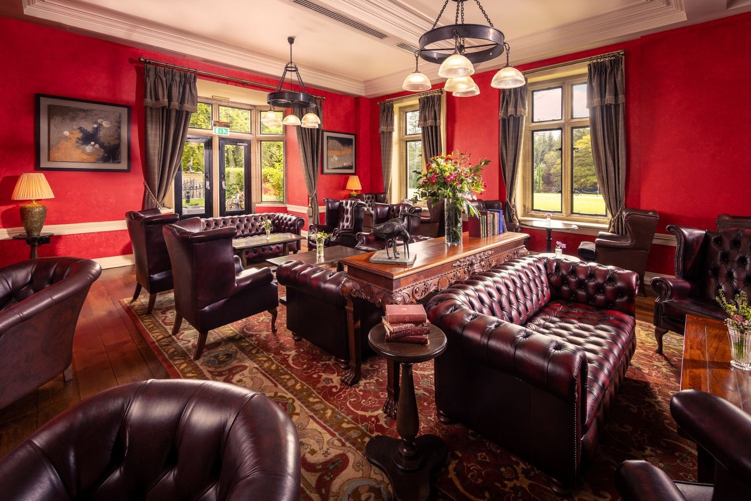 A seating area in a bar with large leather couches and tables