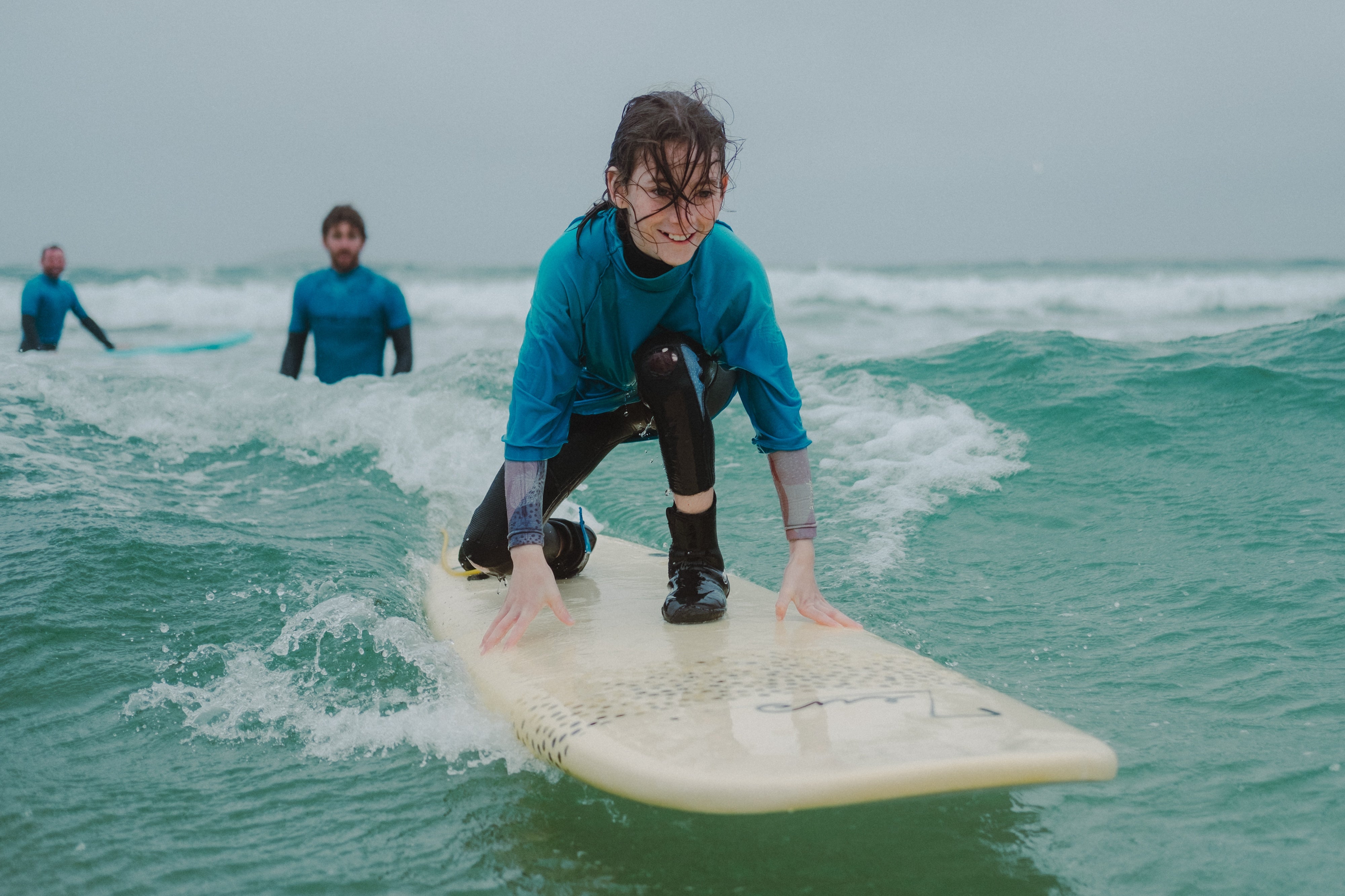 Child learning to surf in County Mayo.