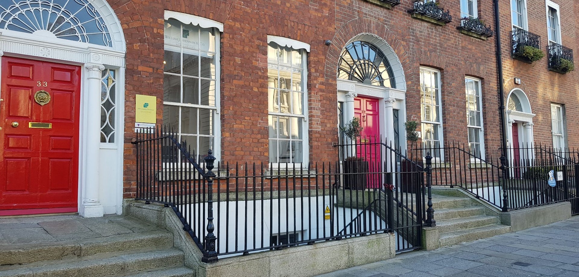 Red brick Georgian terrace in Dublin city with red doors