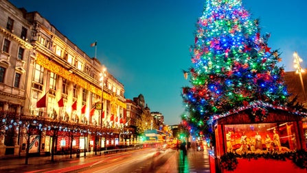 A large Christmas tree on a Dublin street with multi coloured lights