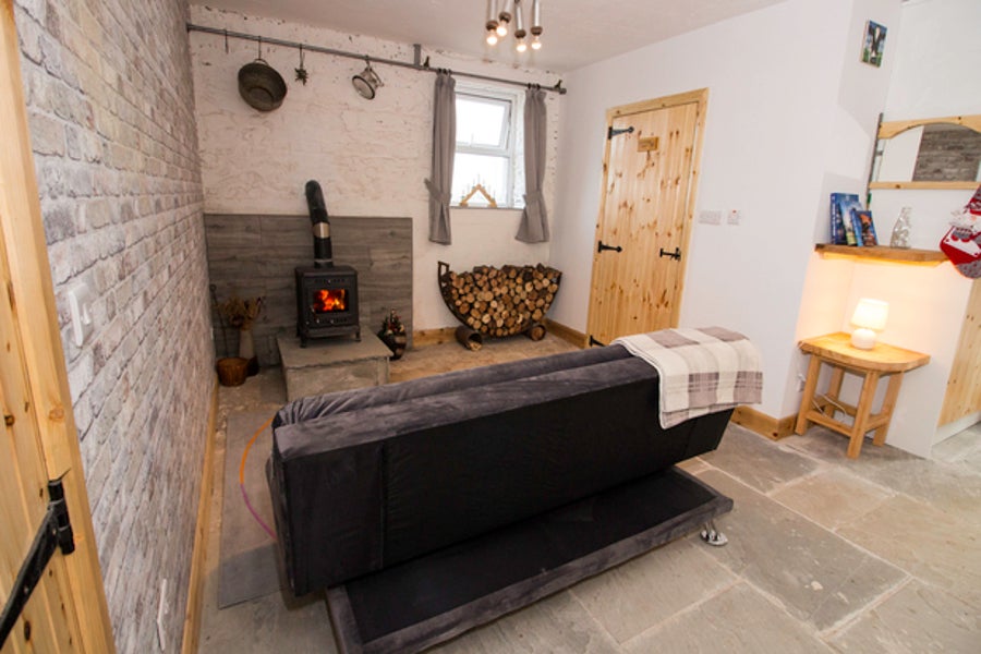 Sitting room with a couch and stove