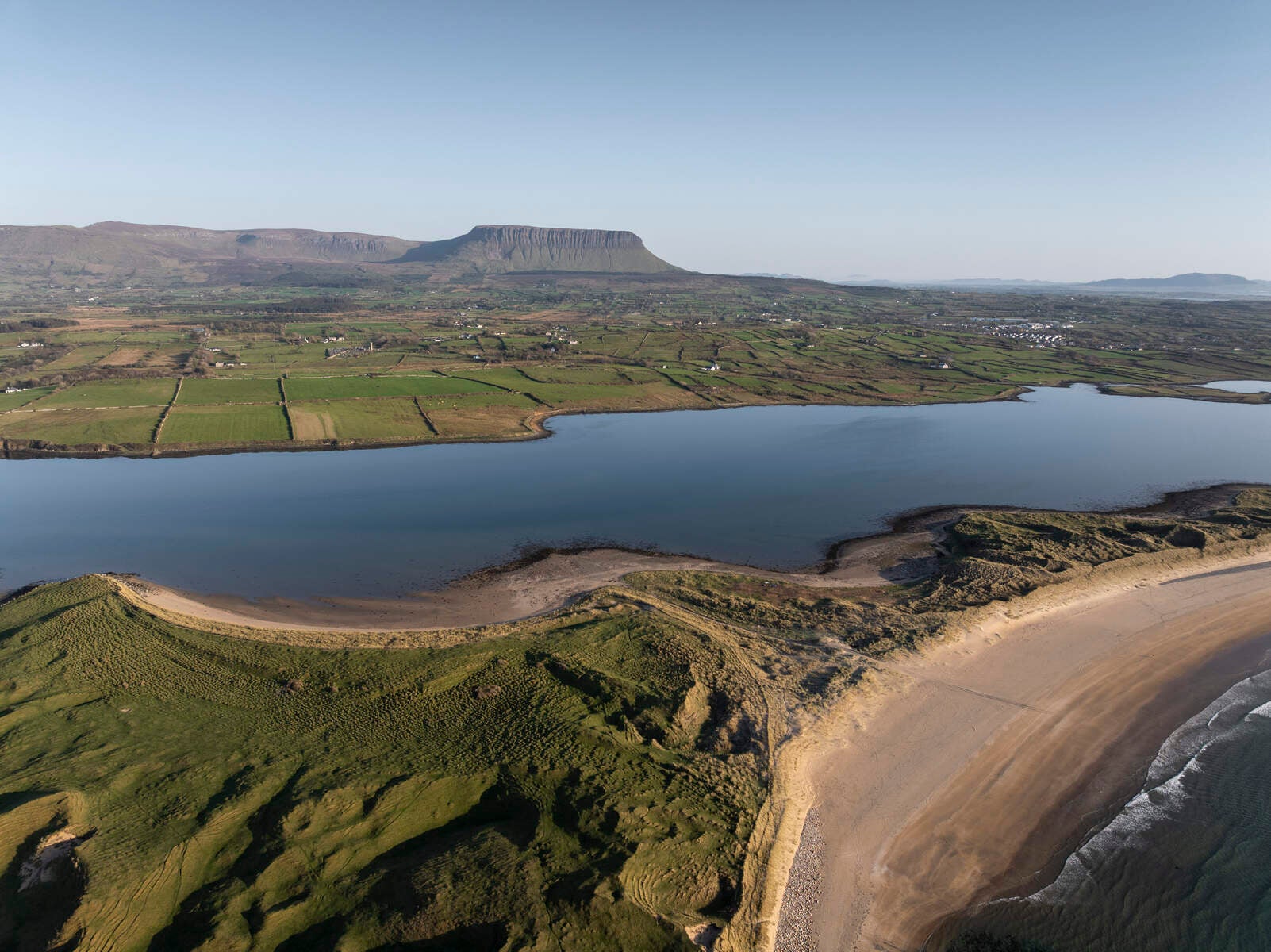 Aerial view of a beach and sea with Benbulben overlooking it