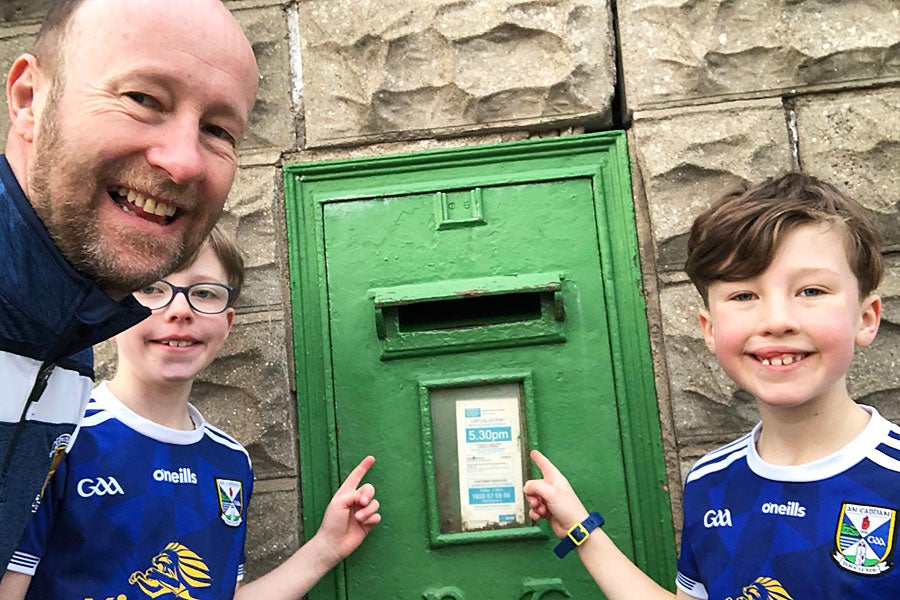 Scavenger Hunting Ireland family pointing to a postbox