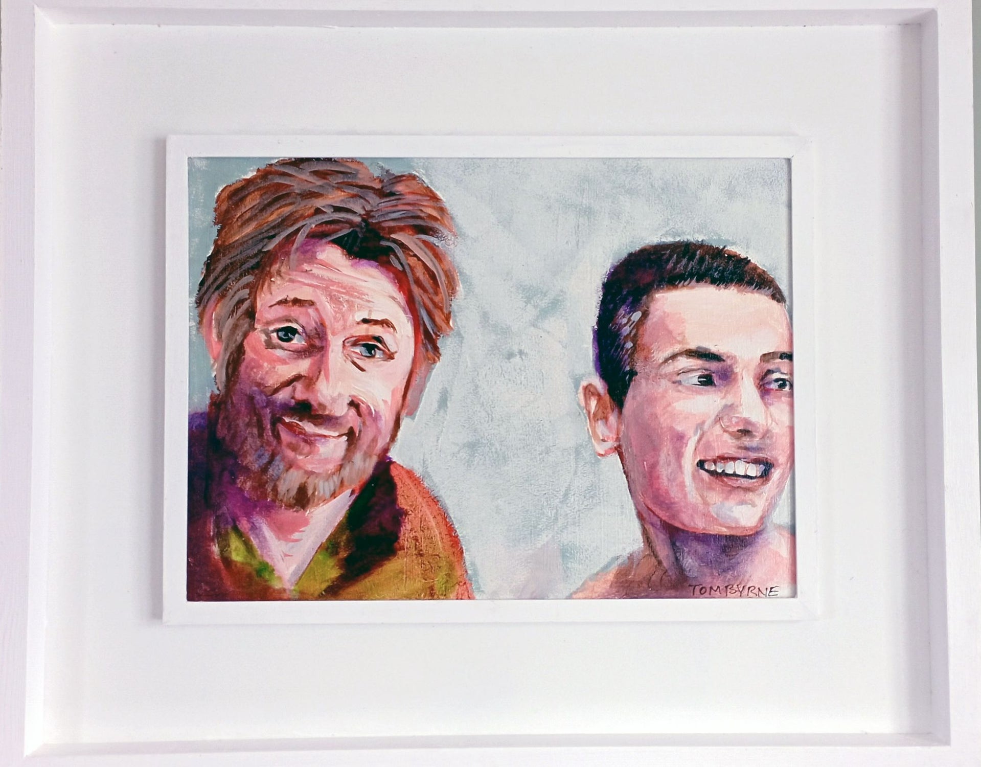 A framed portrait painting featuring two smiling faces